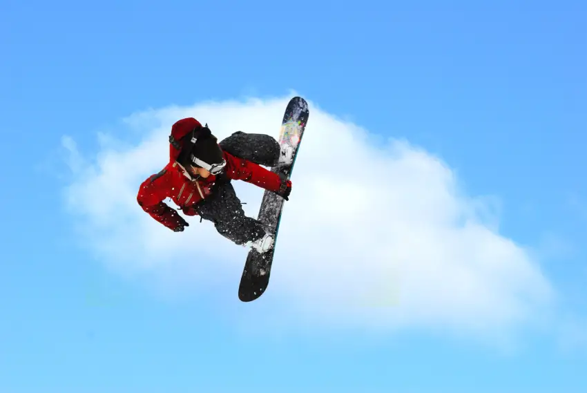 A person on a snowboard in the air.